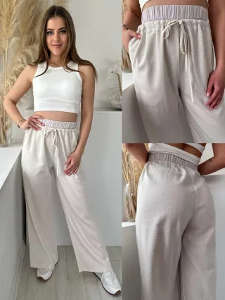   Lenvászon hatású, magas, gumis derekú, nem rugalmas anyagú, lenge fazonú, zsebes nadrág. A Modell S/M méretet visel. (S/M és L/XL méretekben.)