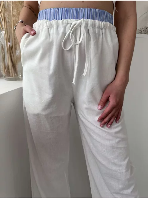 Lenvászon hatású, magas, gumis derekú, nem rugalmas anyagú, lenge fazonú, zsebes nadrág. A Modell S/M méretet visel. (S/M és L/XL méretekben.)