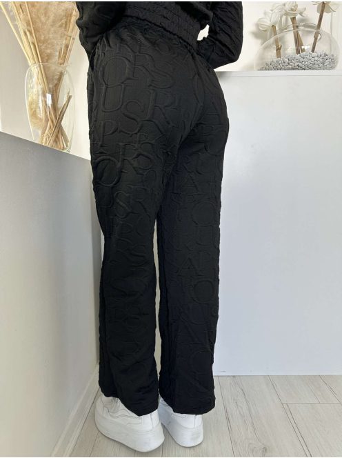 Kétrészes melegítő szett. Nem rugalmas anyagú, rövid, gumis derekú, kapucnis kardigán, magas, gumis derekú, zsebes nadrággal. A Modell S/M méretet visel. (S/M, L/XL és 2XL/3XL méretekben.)