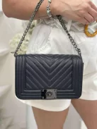 Merev fazonú, műbőr, láncos pántú táska. Szélesség: 23 cm Magasság: 15 cm.